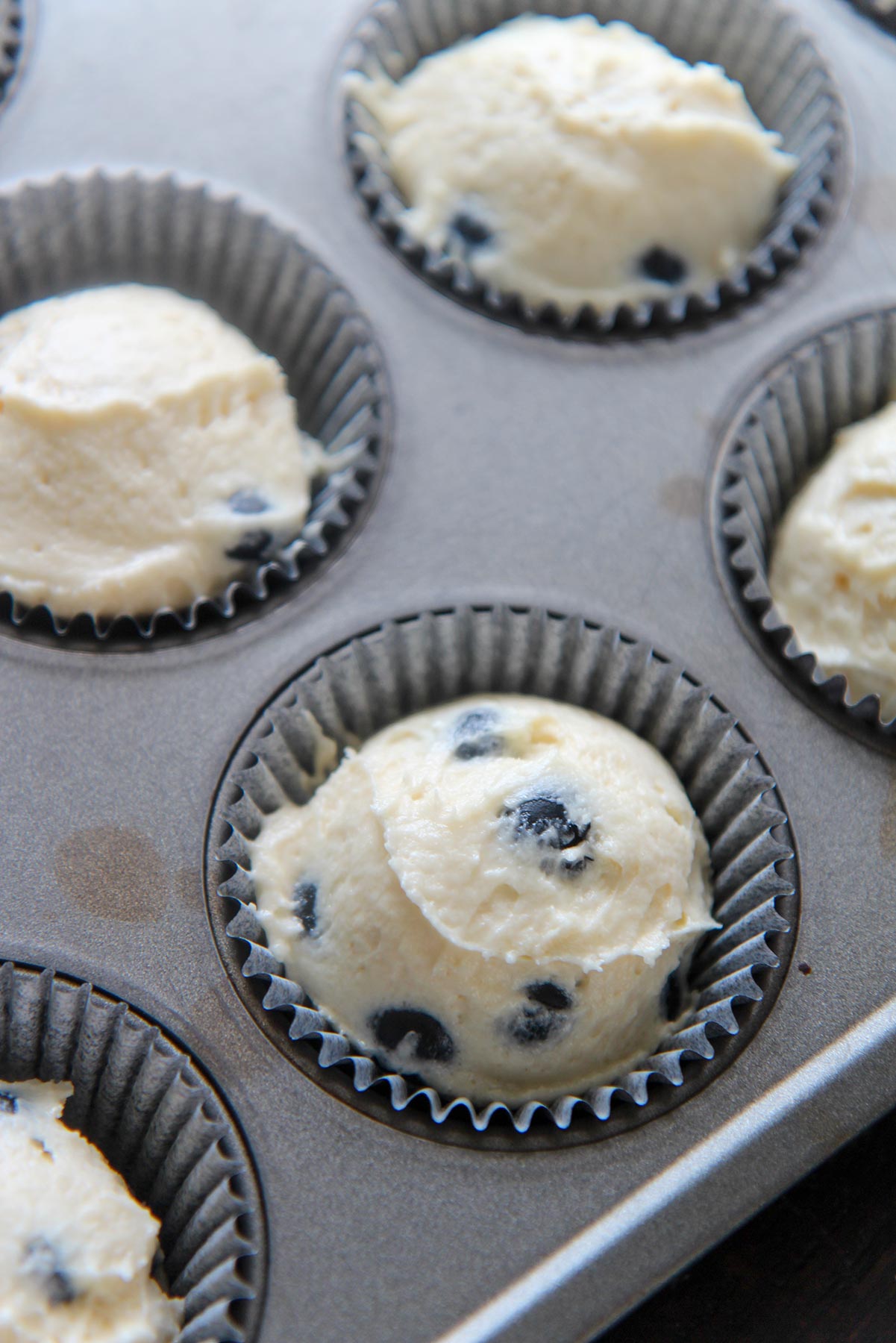 cake batter in a muffin tin 