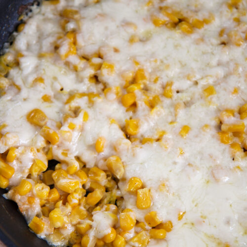 corn and cheese in a black skillet.