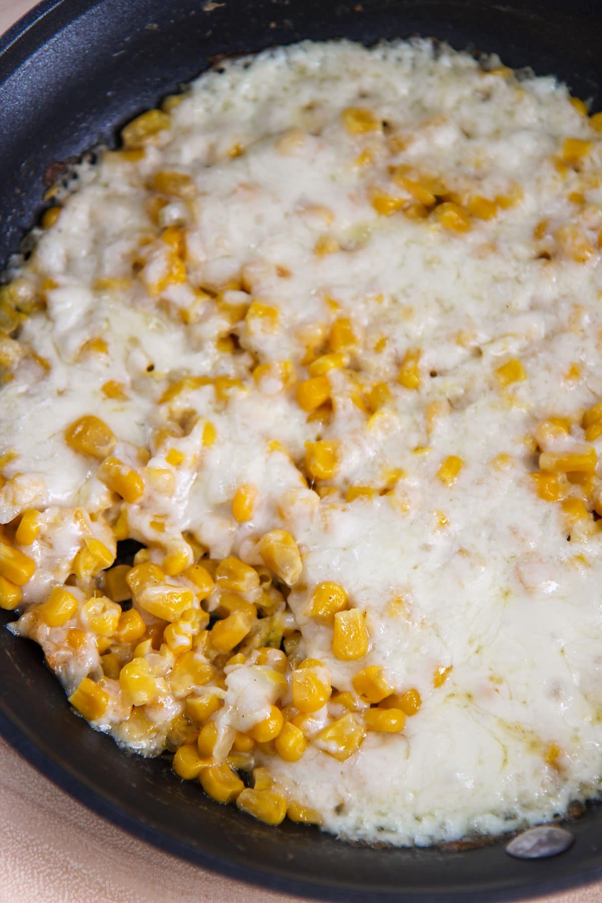 corn and cheese in a black skillet.