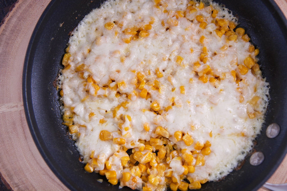 cheesy corn in a skillet. 