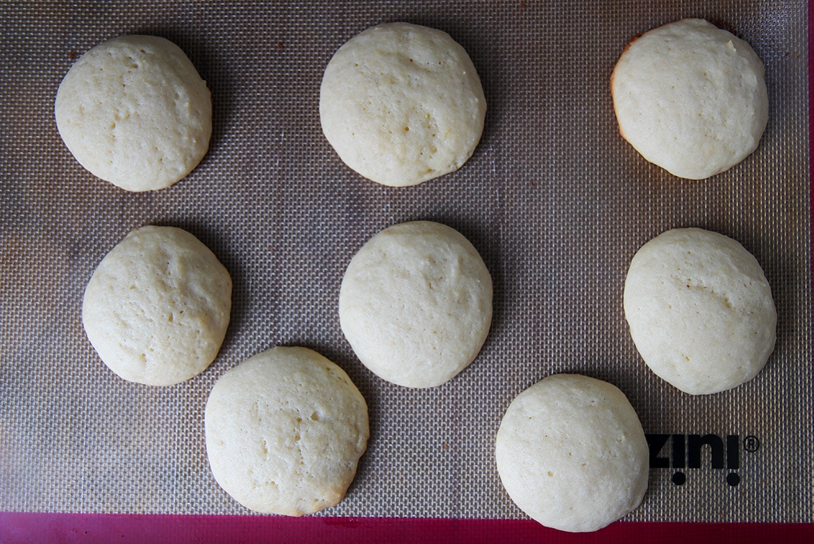 eight soft baked cookies on a baking sheet. 