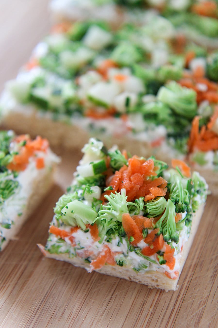 two squared vegetable bars on a wooden board