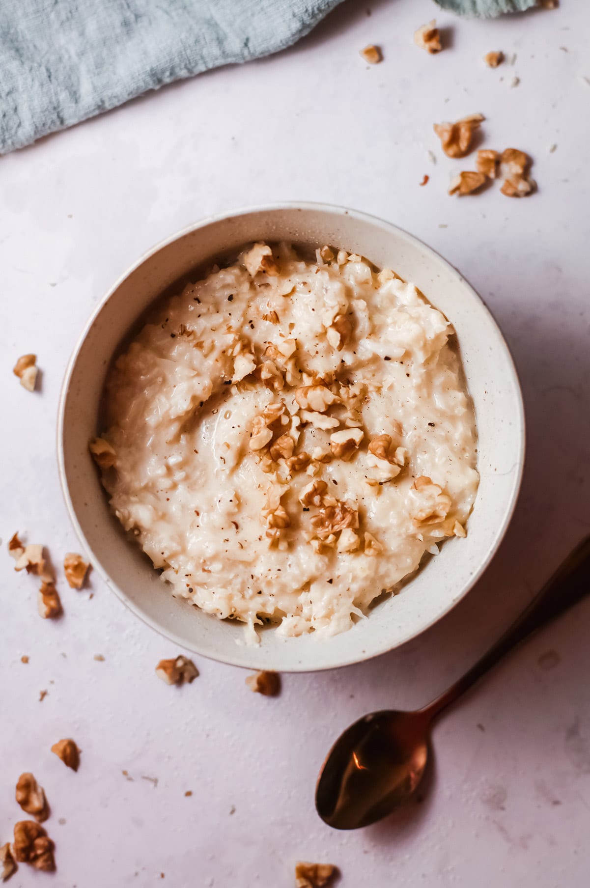 keto vegan risotto in a white bowl with a spoon on the side