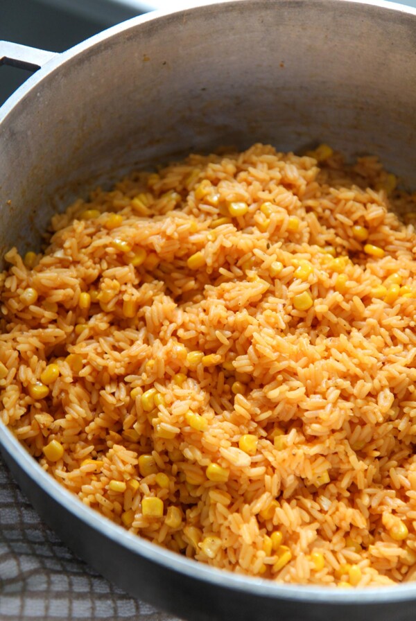 yellow rice with corn in a big pot.