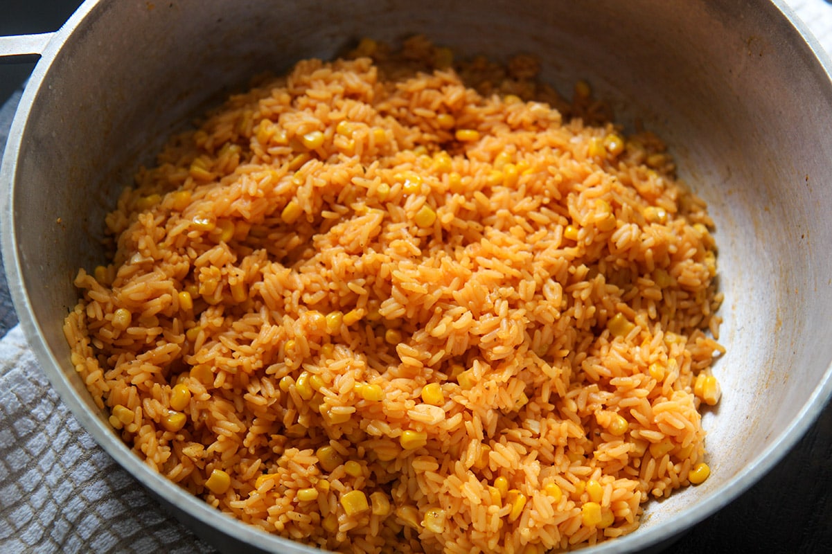 a horizontal photo of yellow rice in a pot.