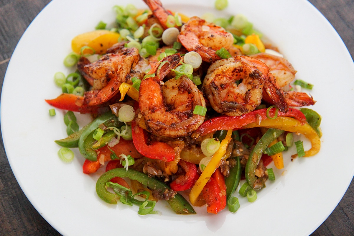 shrimp and veggies on a white plate.