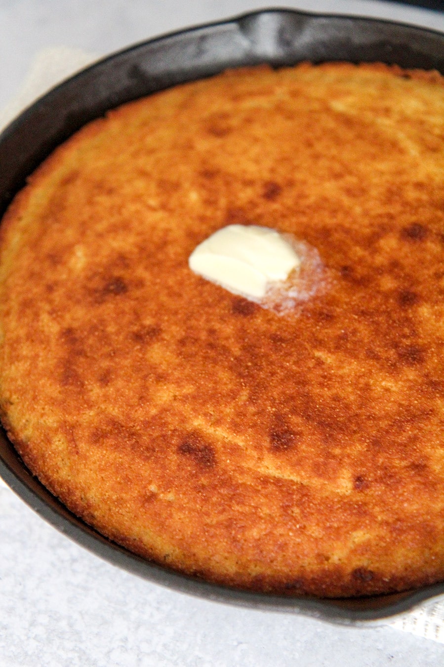 cornbread in a 10 inch black iron skillet. 