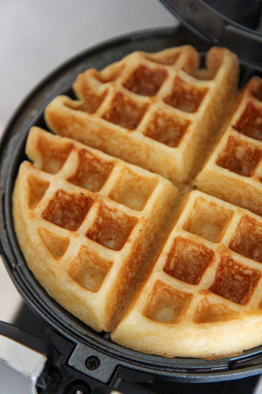 cooked waffle in a waffle iron.