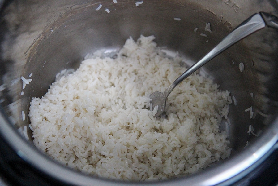 cooked jasmine rice in the instant pot with a fork. 