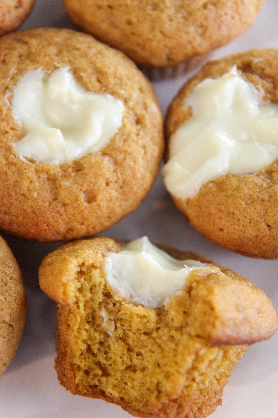 three pumpkin cheesecake muffins up close. 