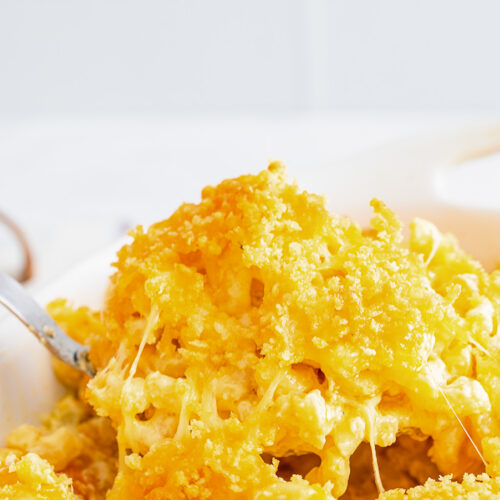 a spoonful of baked mac and cheese up close.
