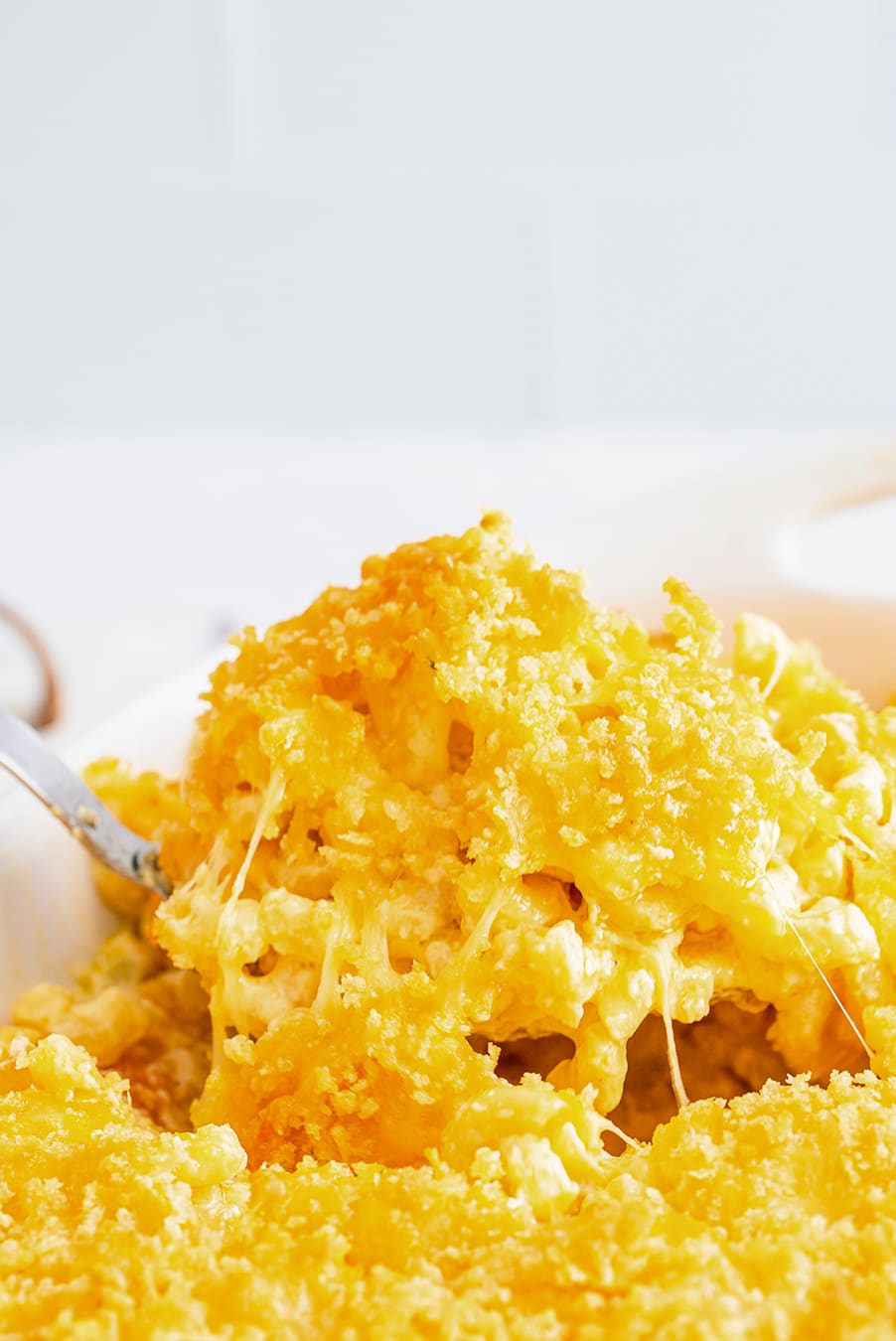 a spoonful of baked mac and cheese up close.