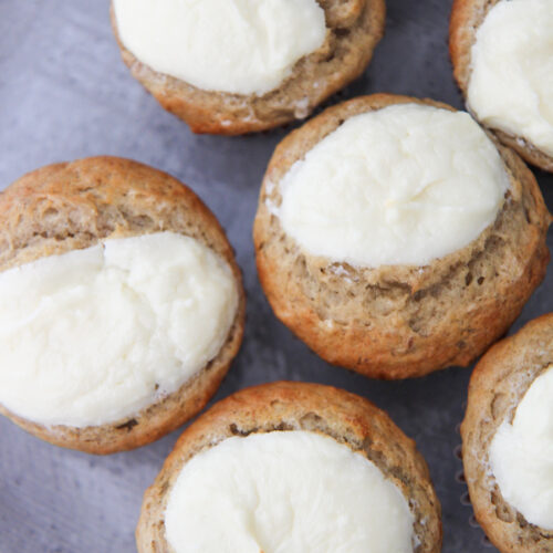 cream cheese banana muffins up close on a gray plate.