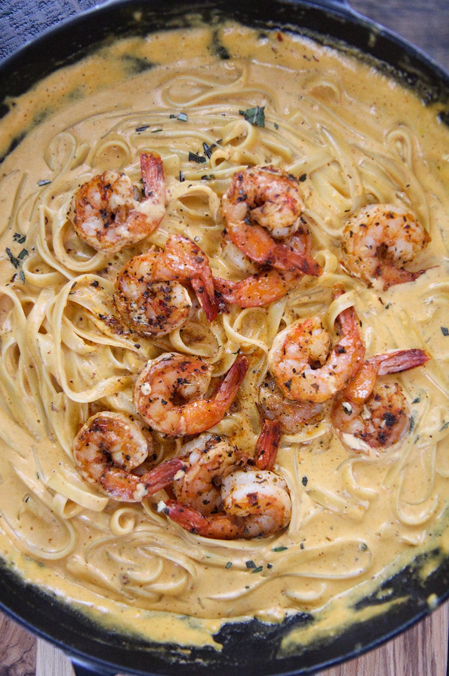 pumpkin fettuccine alfredo  with shrimp in a cast iron skillet. 