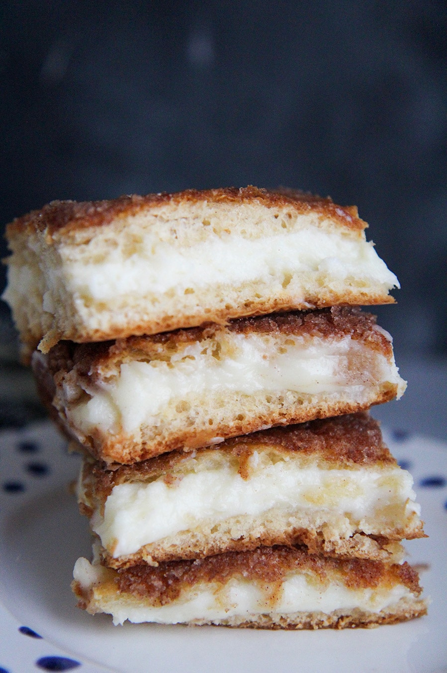 four cheesecake bars stacked on top of each other 