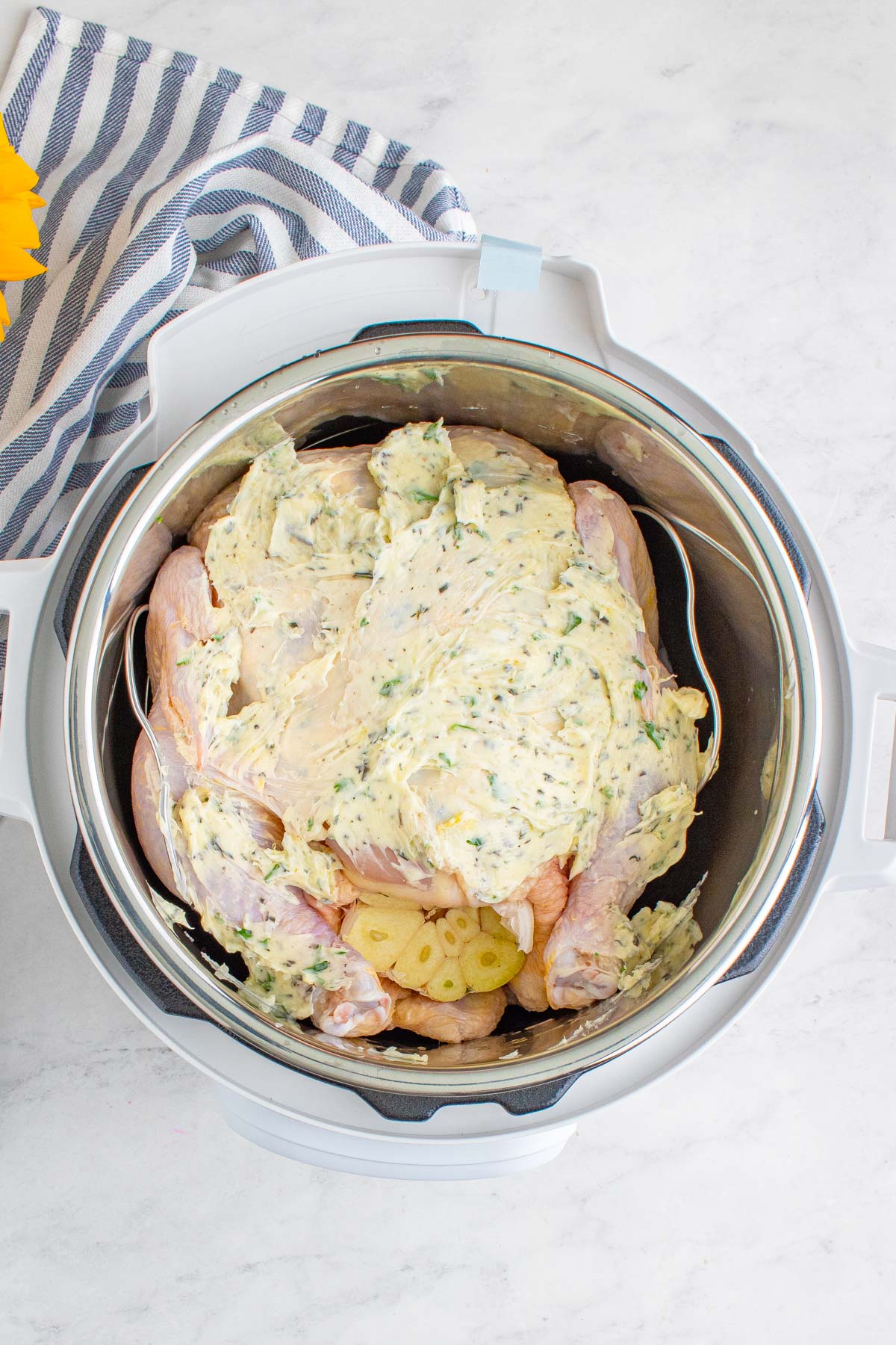 raw chicken with butter and herbs in the pressure cooker. 