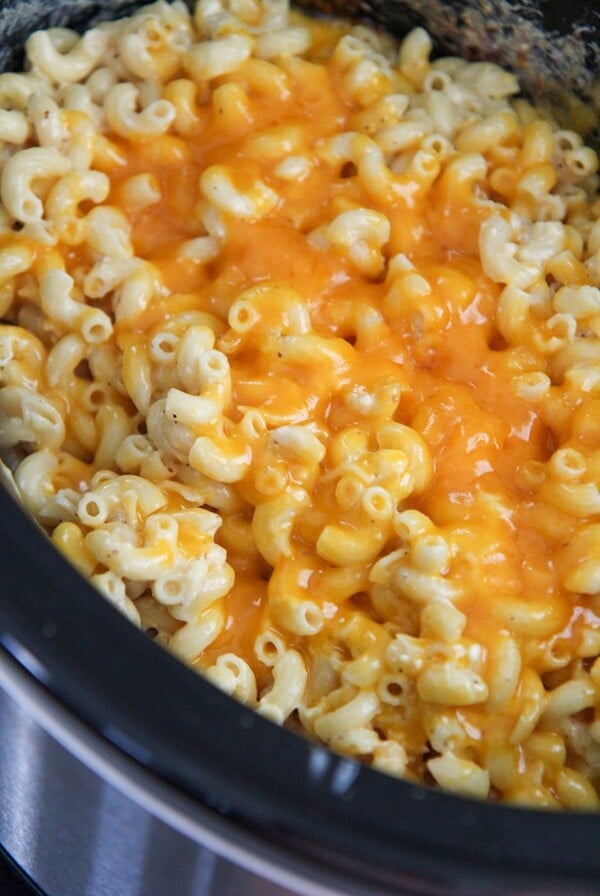 mac and cheese in the crockpot with yellow melted cheese on top