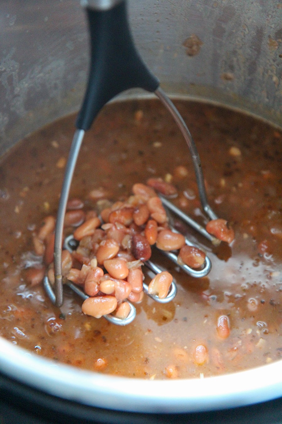 cooked pinto beans in the instant pot with a potato masher.