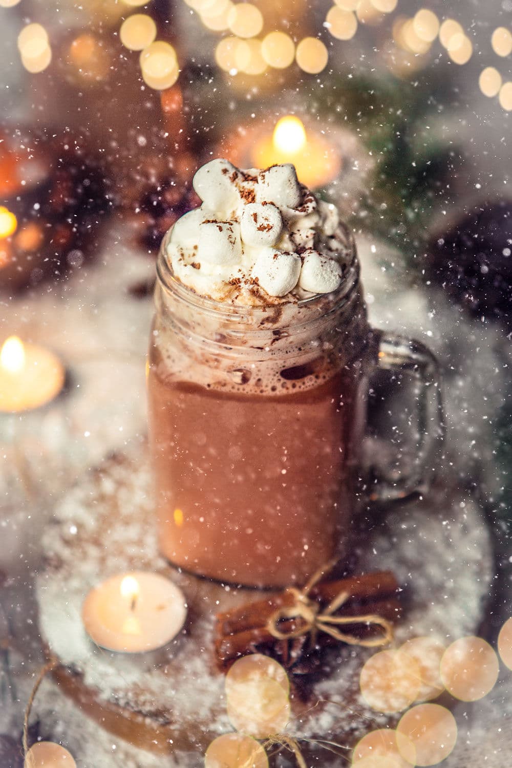 hot chocolate in a glass mug with marshmallows on top.