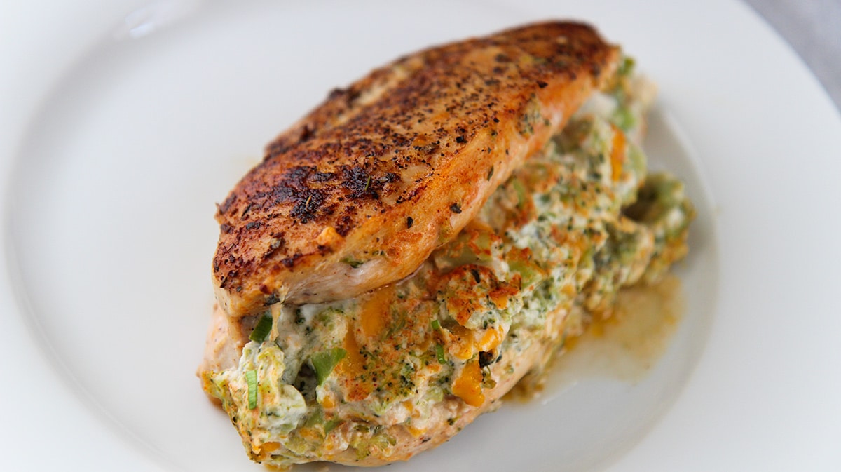 broccoli cheese stuffed chicken on a white plate.