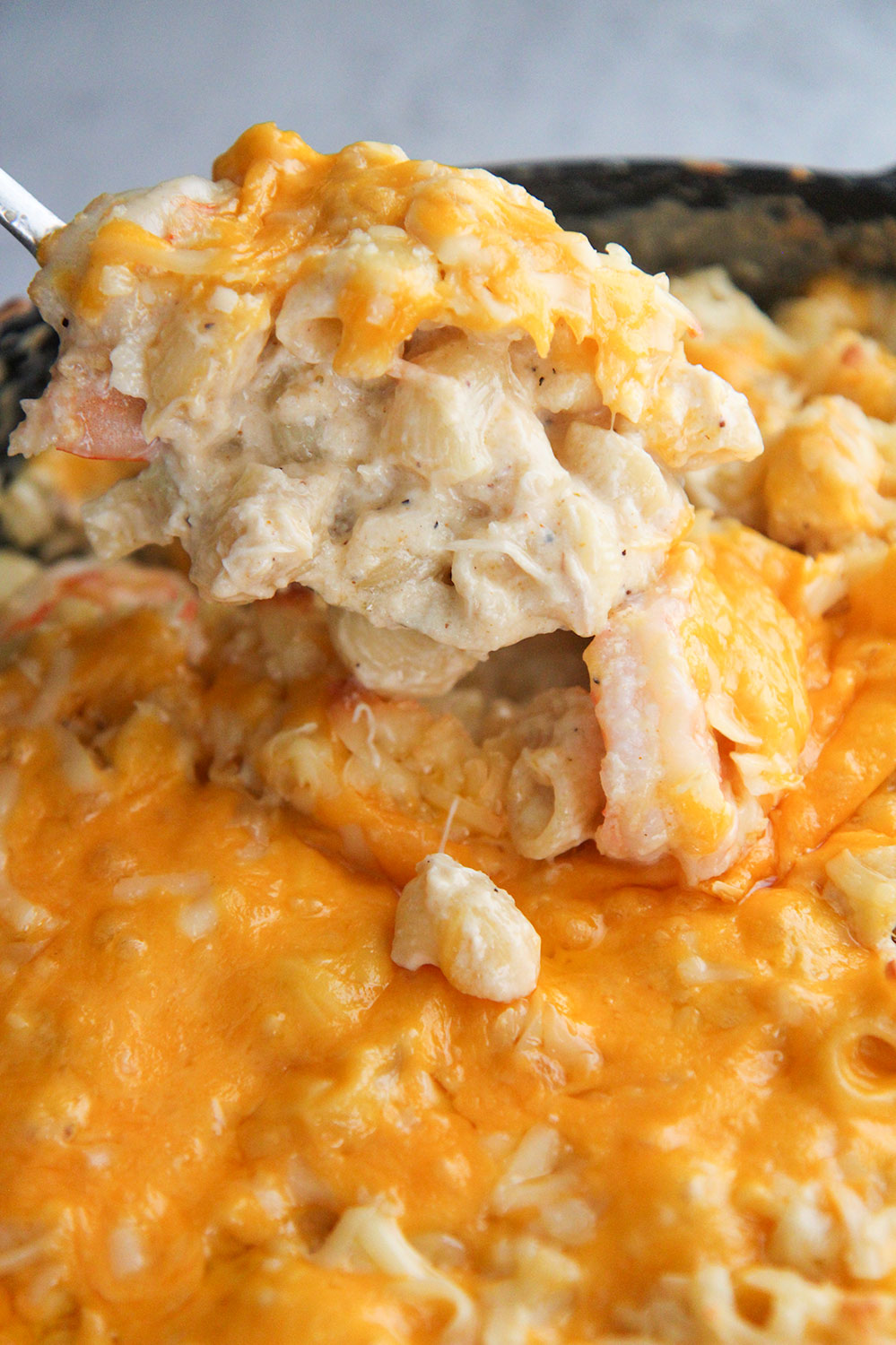 a spoonful of seafood mac and cheese up close. 