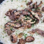 truffle mushroom risotto with parsley on top.