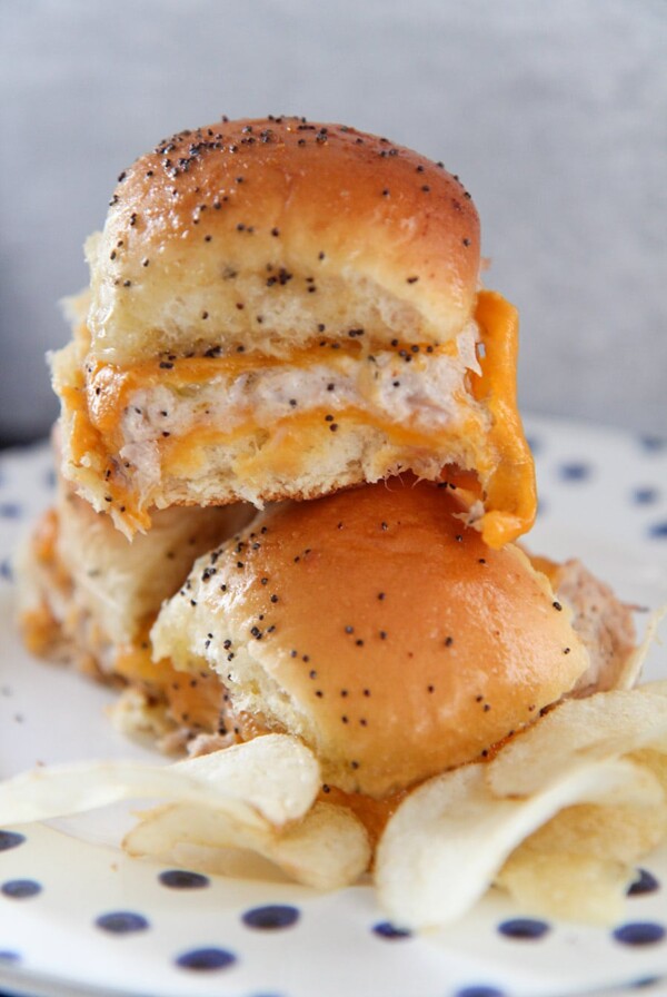 three hot tuna melt sliders with chips on a plate.