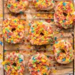8 fruity pebble donuts on a wire rack
