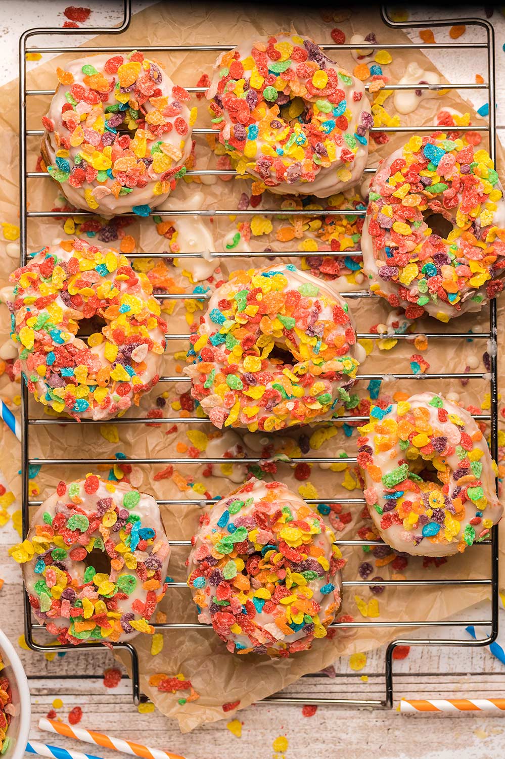 8 fruity pebble donuts on a wire rack 