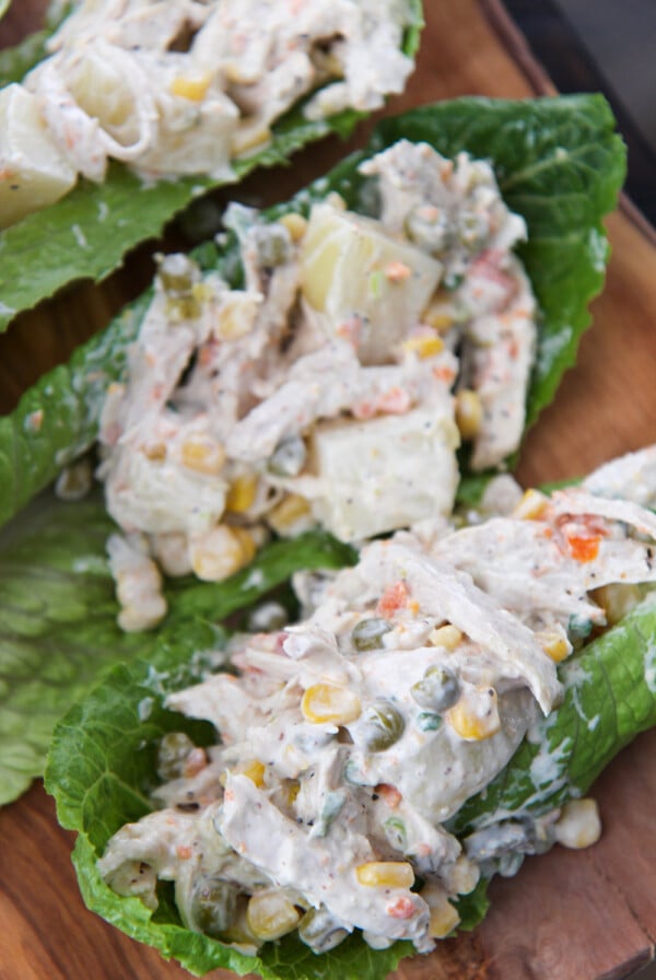 ensalada de pollo (chicken salad) on three lettuce cups.