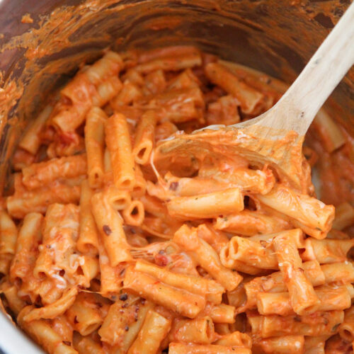 baked ziti in the instant pot with a wooden spoon