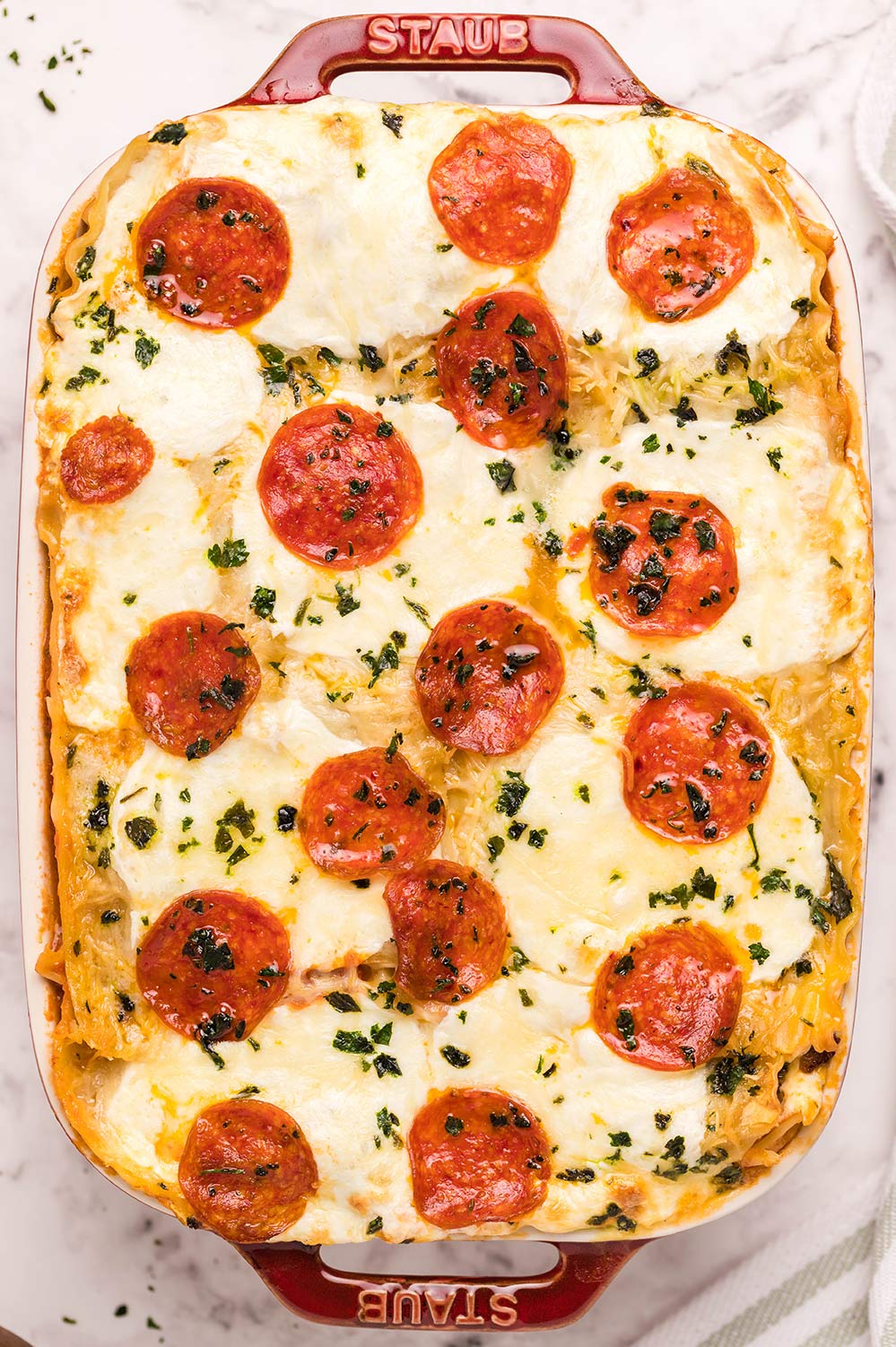 pizza lasagna in a red casserole 