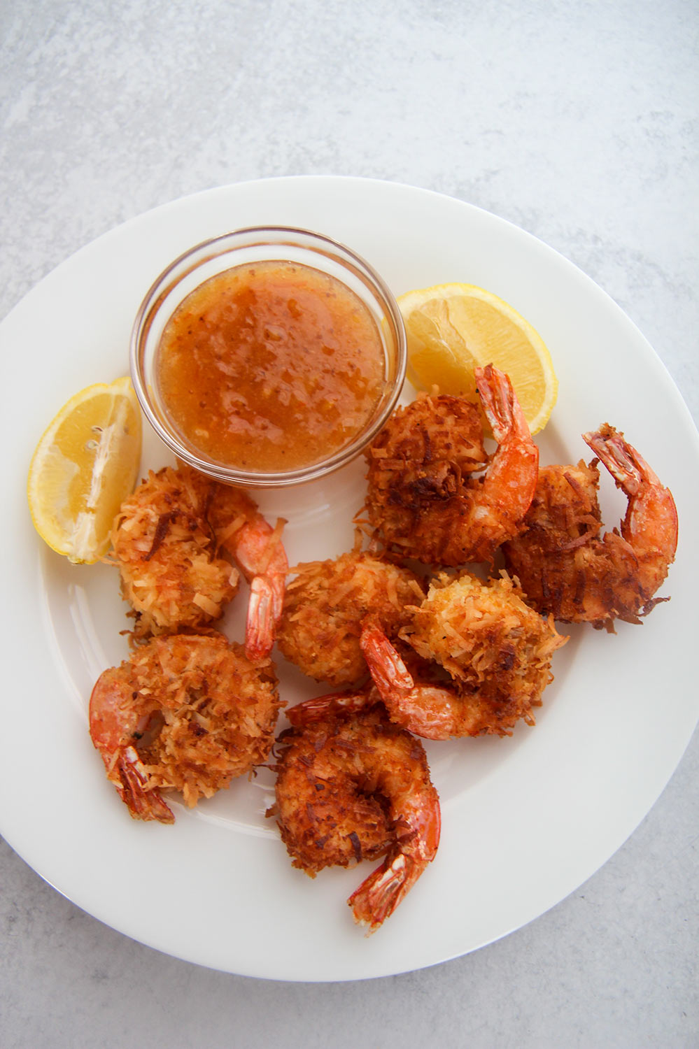 coconut shrimp on a white plate.