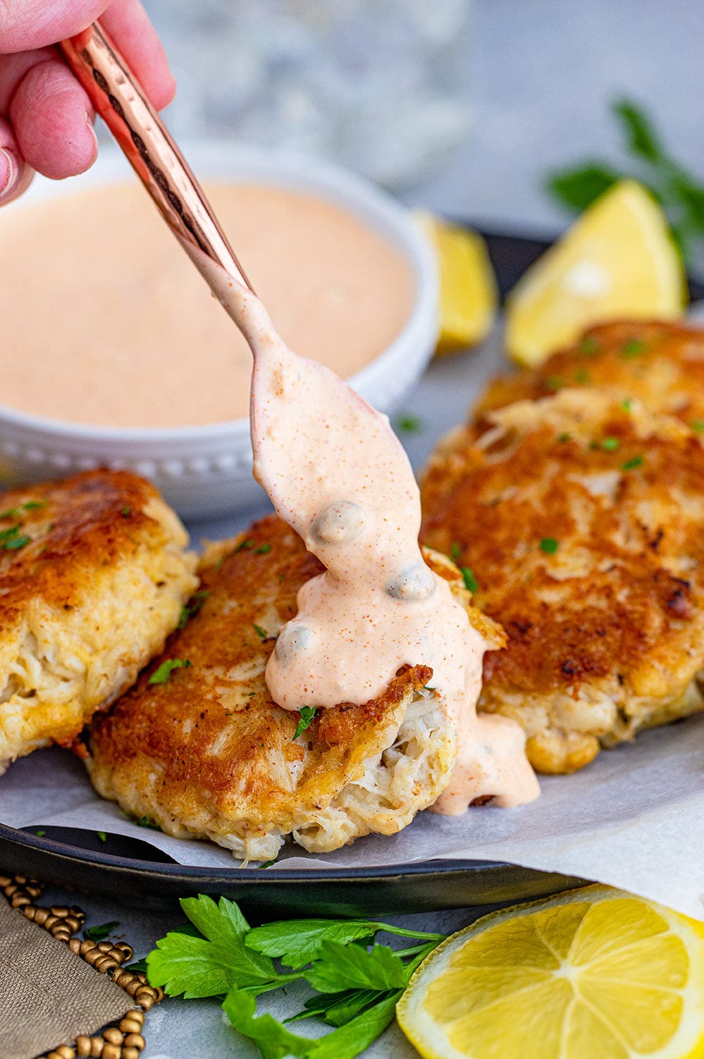crab cakes with remoulade sauce on top
