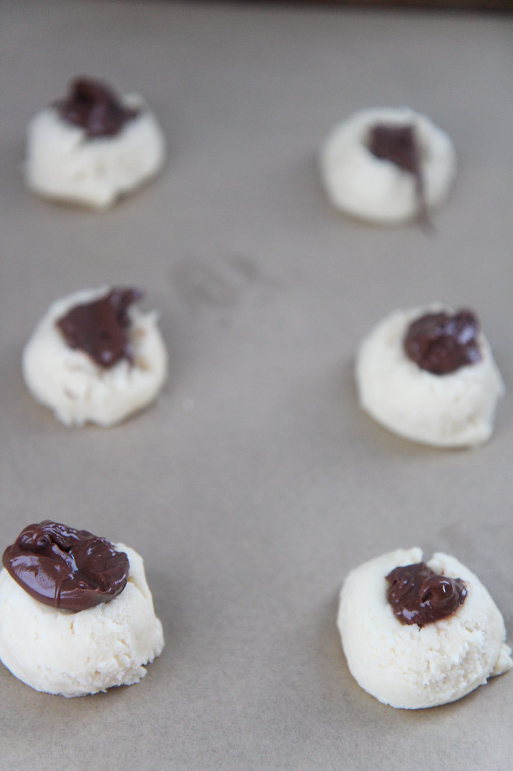 6 cookie balls with nutella on top. 
