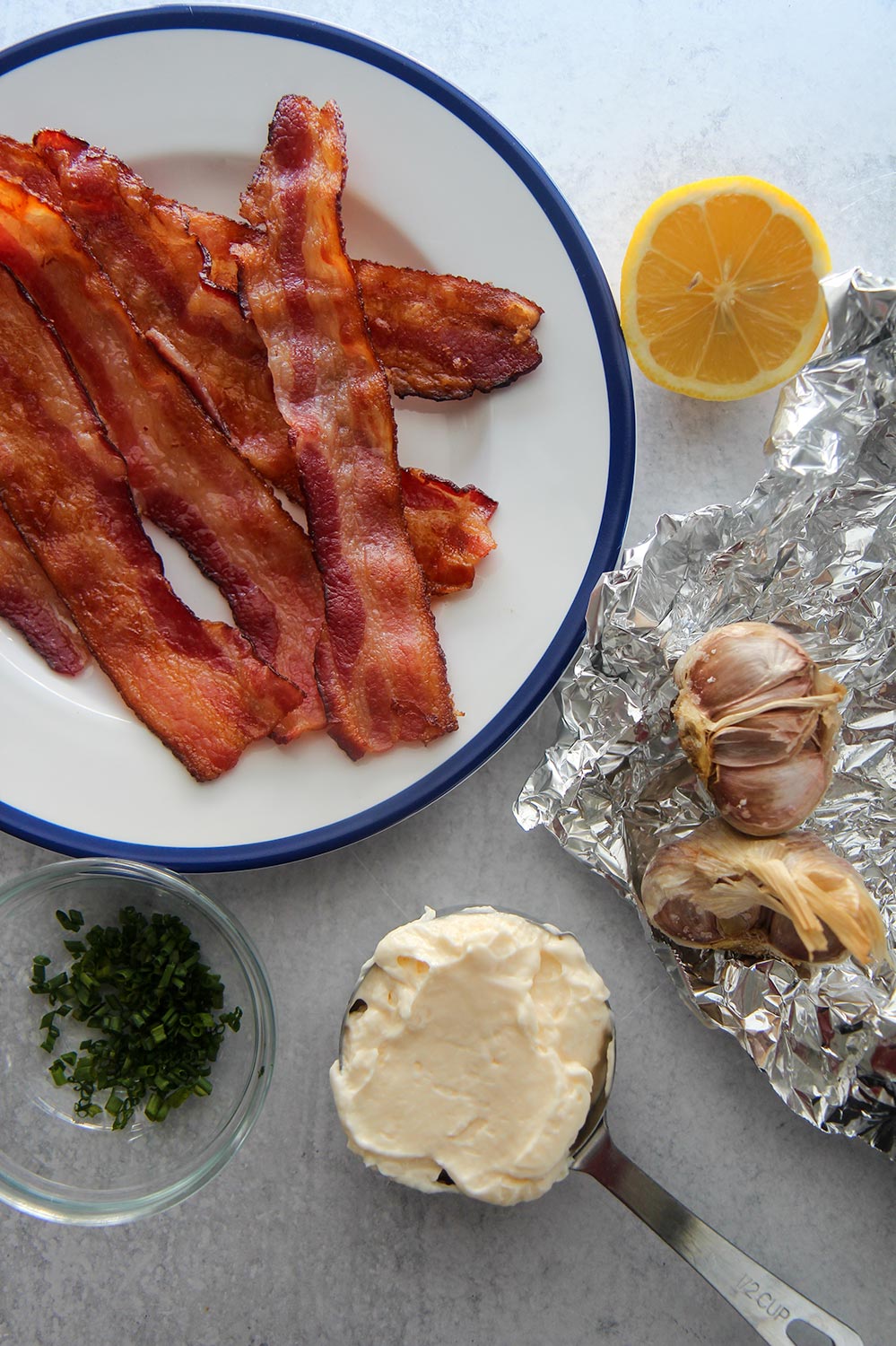 bacon, lemon, chives, mayo, and roasted garlic on aluminum foil.