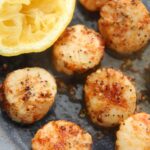 air fryer scallops with a lemon on the side.