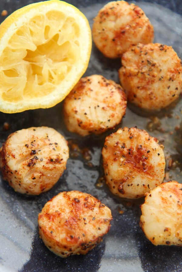 air fryer scallops with a lemon on the side.