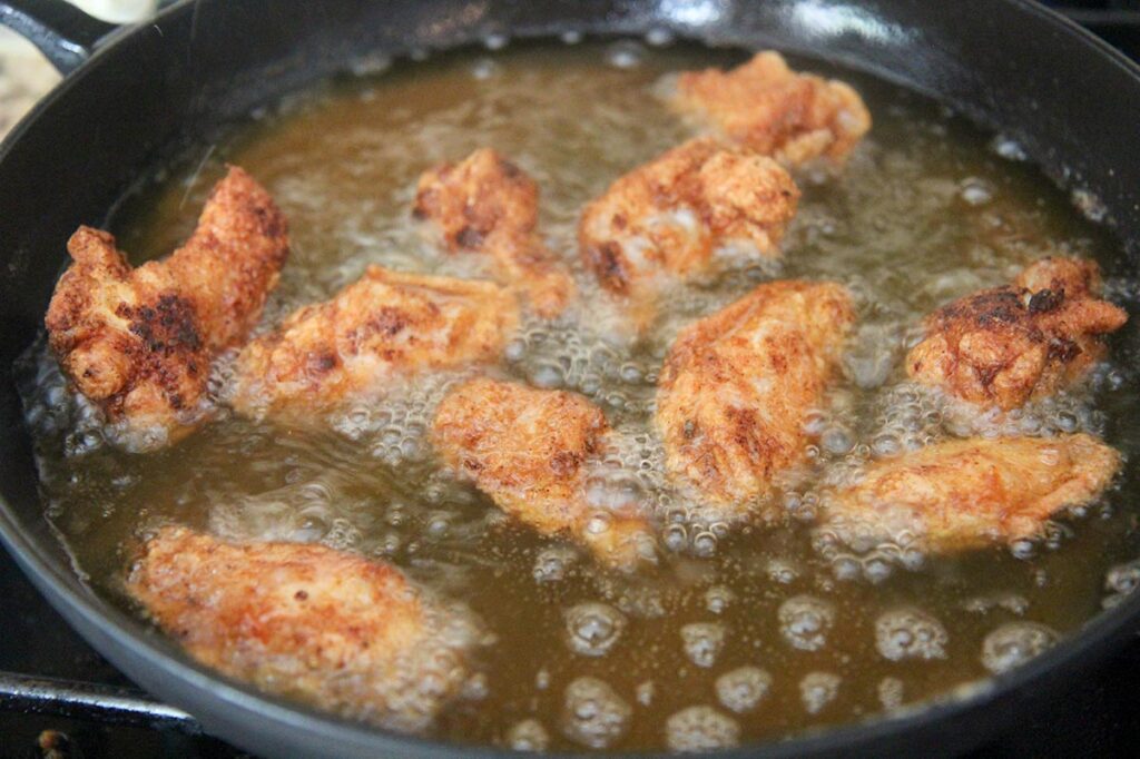 chicken wings frying in oil