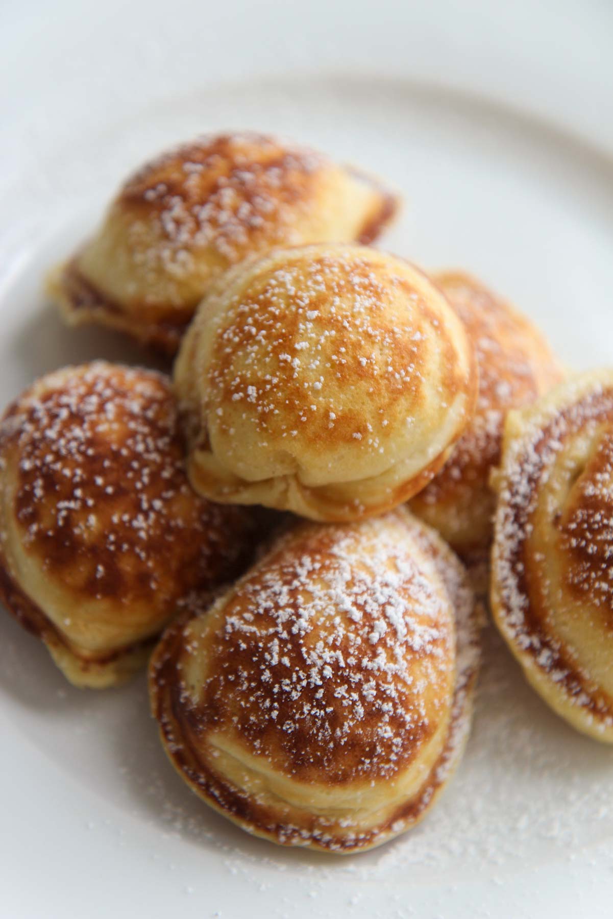 Mini Pancakes with powdered sugar on top, up close. 