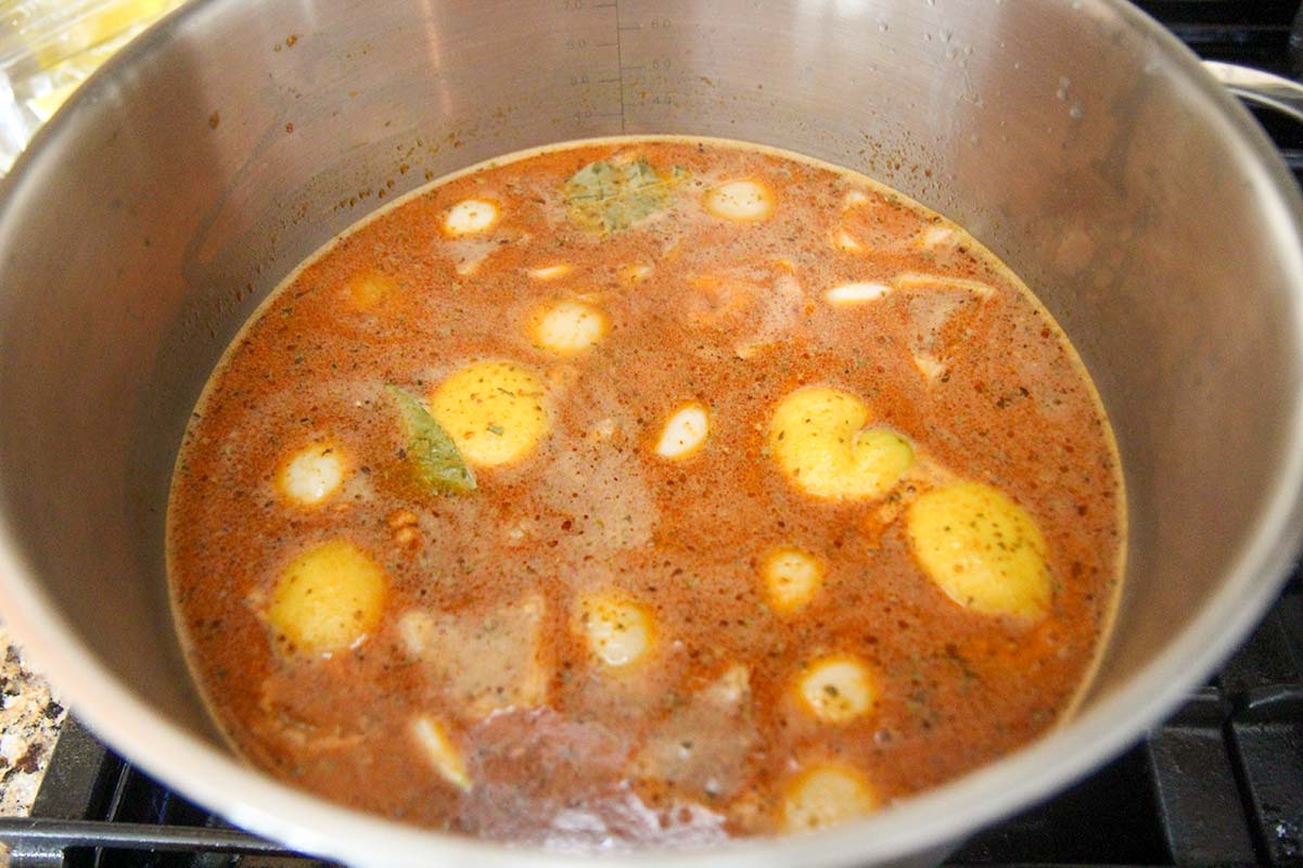 seasoned reddish broth in a large stock-pot over the stovetop. 