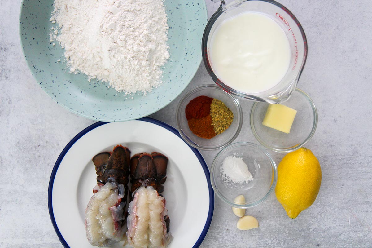 flour, raw lobster tails, buttermilk, spices, garlic, butter, baking powder, and a lemon. 