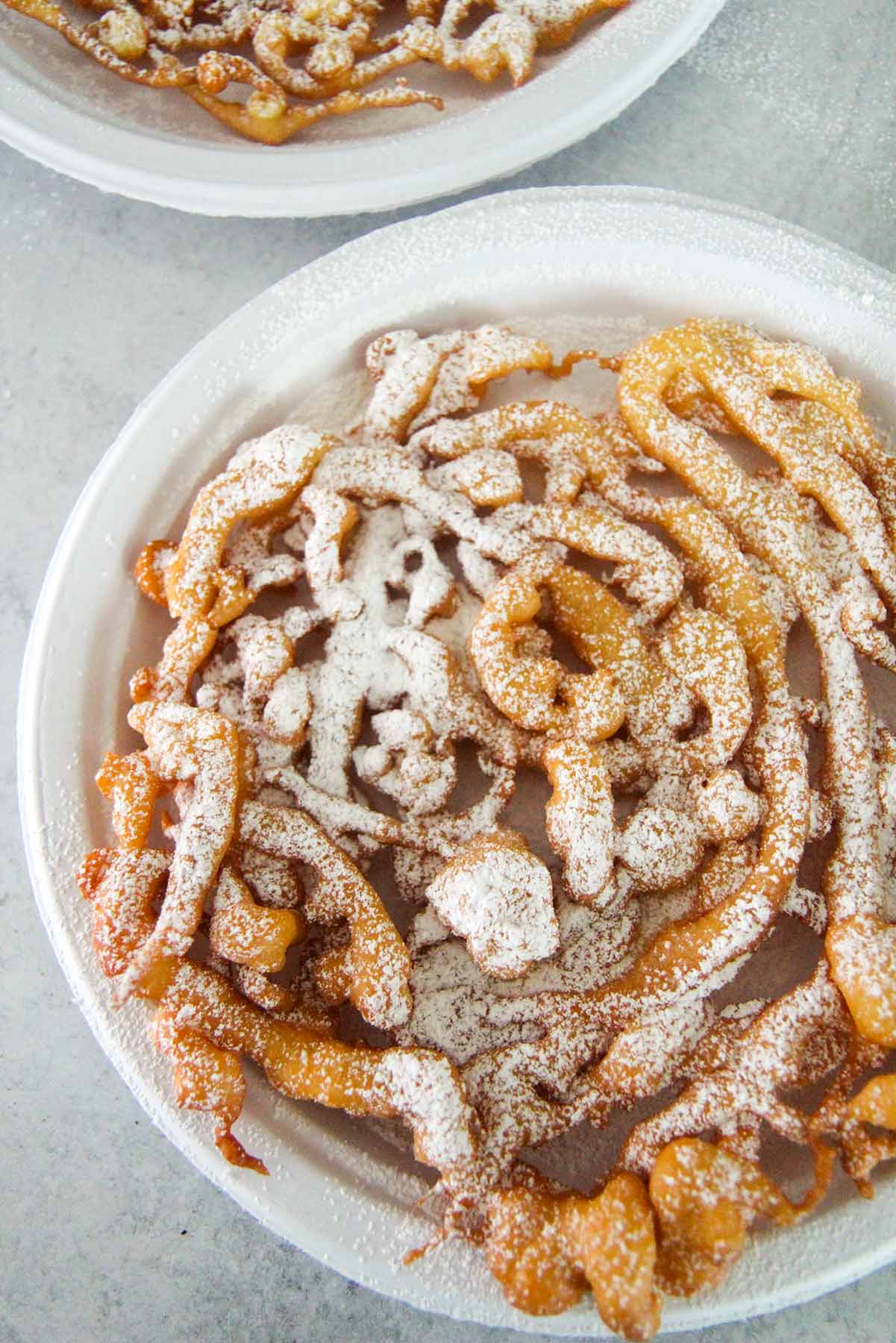 funnel cake on a white plate. 