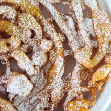 Funnel cake up close with powdered sugar on top.