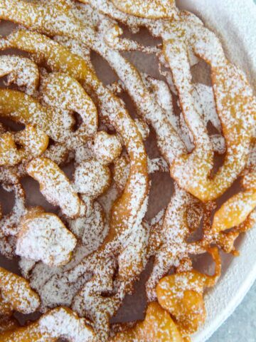Funnel cake up close with powdered sugar on top.