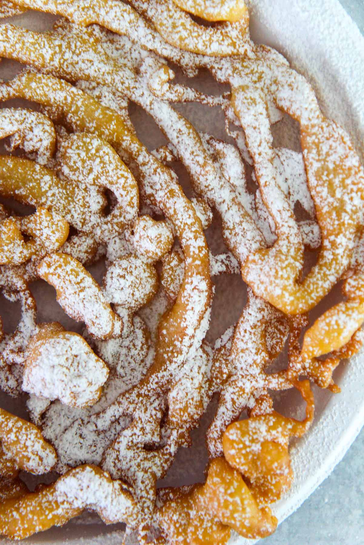 Funnel cake up close with powdered sugar on top. 