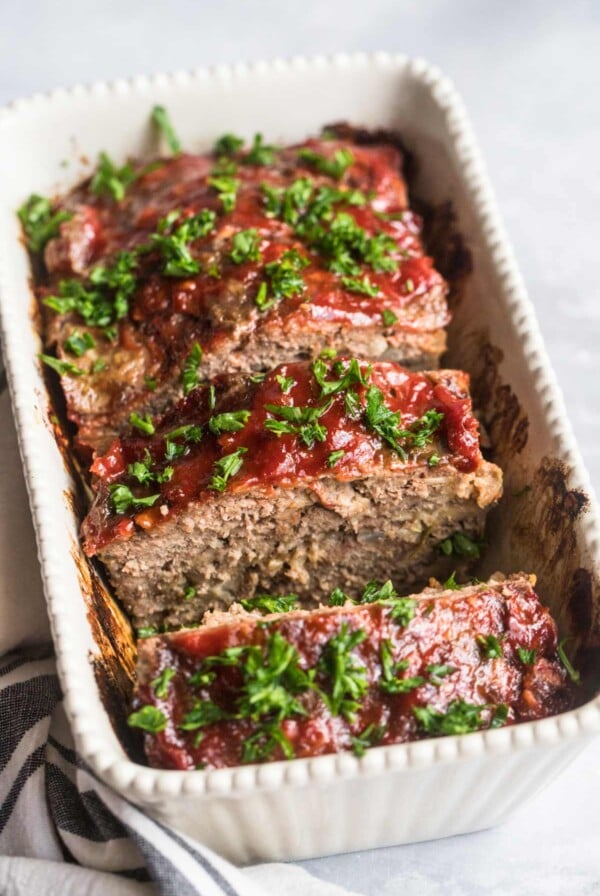 sliced meatloaf with fresh parsley on top.