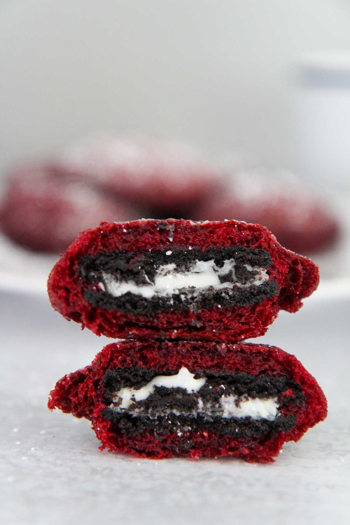 two red velvet fried oreos stacked on top of each other. 