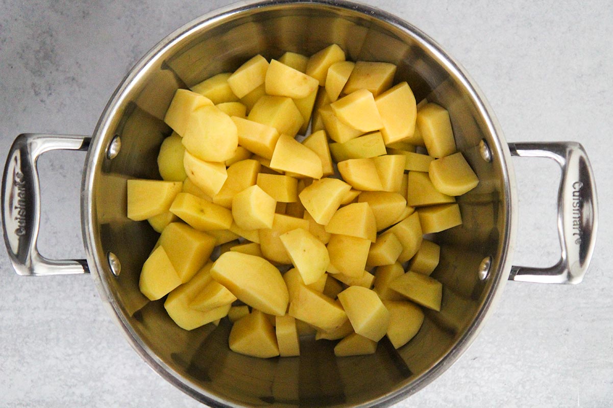 peeled and cooked potatoes in a pot.