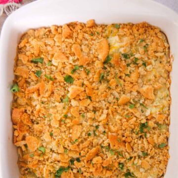 Southern yellow squash casserole in a white baking dish.